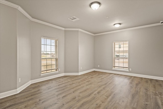 unfurnished room featuring ornamental molding and hardwood / wood-style floors