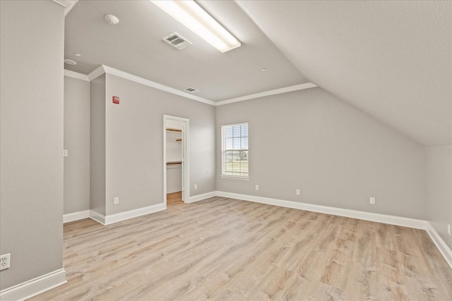 bonus room featuring lofted ceiling and light hardwood / wood-style flooring