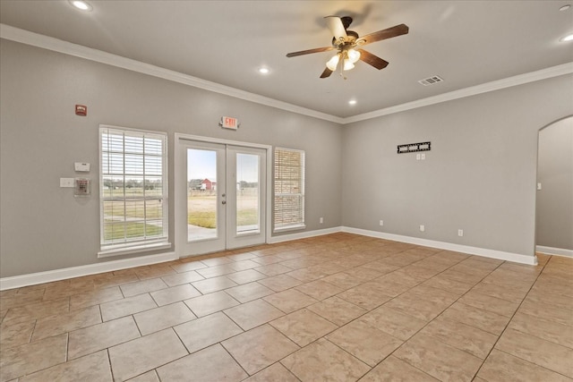 tiled empty room with crown molding, ceiling fan, and french doors