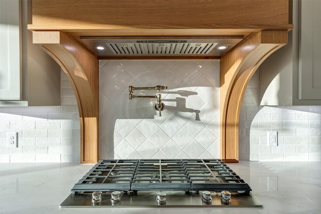 kitchen with gas cooktop, extractor fan, and backsplash