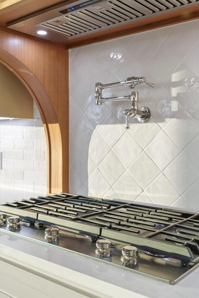 interior details with tasteful backsplash and stainless steel gas stovetop