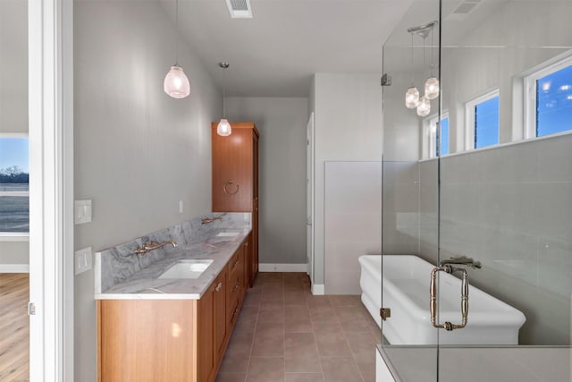 bathroom featuring tile patterned floors, separate shower and tub, and vanity