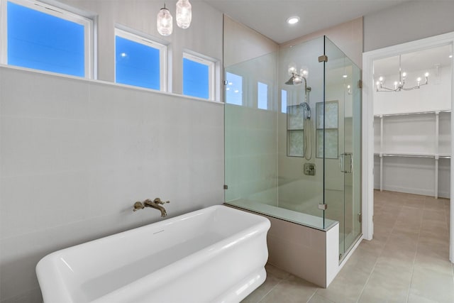 bathroom featuring tile patterned flooring and plus walk in shower