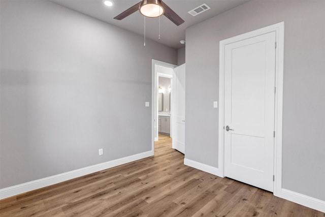 unfurnished bedroom featuring ceiling fan and light wood-type flooring