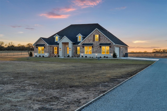 view of front of house with a yard and a garage