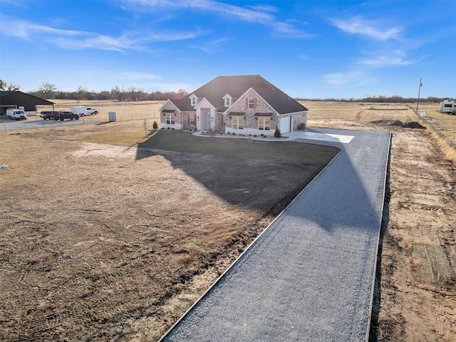 view of front facade with a rural view and a garage