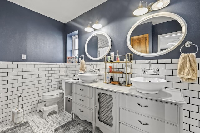 bathroom featuring tile walls, vanity, tile patterned floors, and toilet