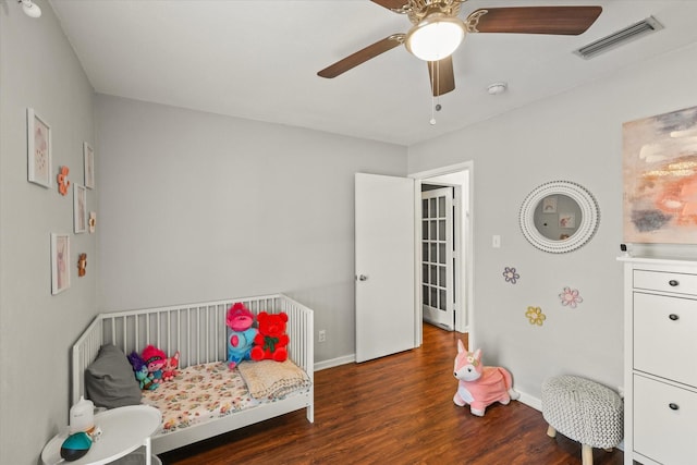 bedroom with ceiling fan and dark hardwood / wood-style floors