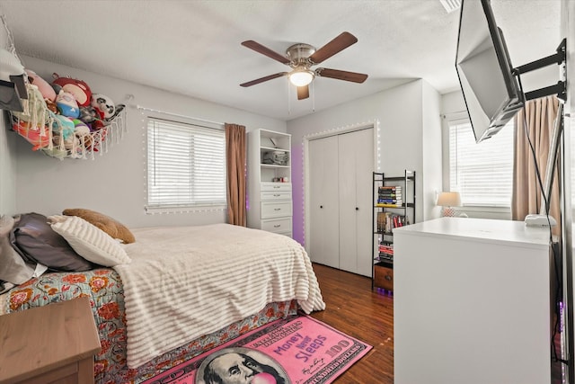 bedroom with a textured ceiling, dark hardwood / wood-style floors, and ceiling fan