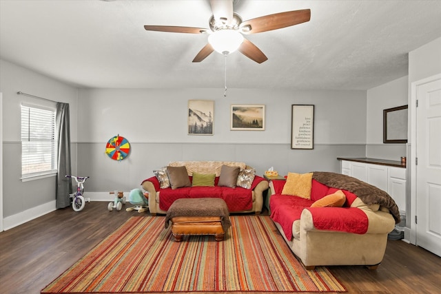 living room featuring ceiling fan and dark hardwood / wood-style floors