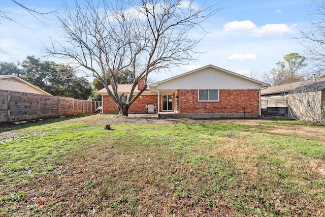 rear view of house featuring a lawn