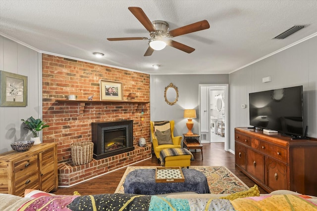 living room with crown molding, a fireplace, and dark hardwood / wood-style flooring