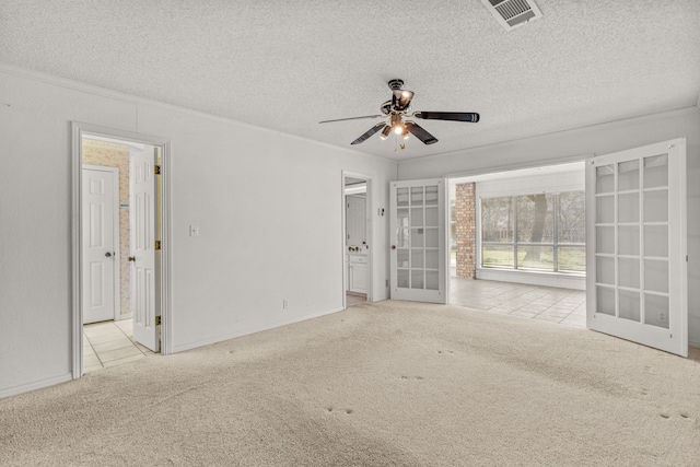 unfurnished room with ornamental molding, ceiling fan, light carpet, a textured ceiling, and french doors