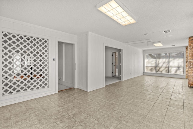 unfurnished room with a textured ceiling