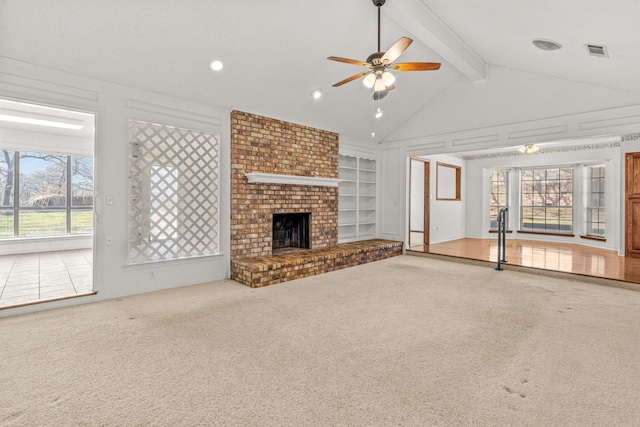 unfurnished living room with a fireplace, built in features, beamed ceiling, and carpet