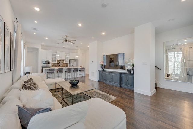 living room with dark wood-type flooring and ceiling fan