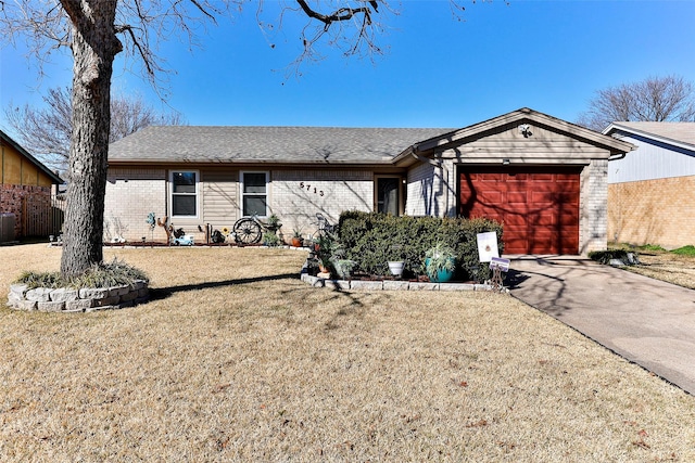 ranch-style house with cooling unit, a garage, and a front yard