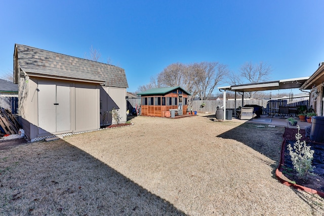 view of yard featuring a hot tub, a wooden deck, and a storage unit