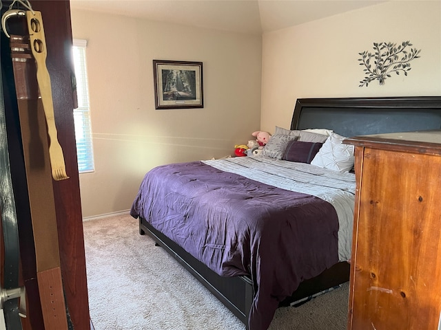 bedroom with light colored carpet and multiple windows