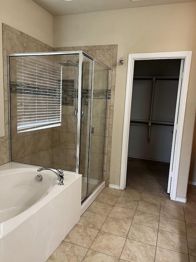 14125 Rabbit Brush Ln, Fort Worth, TX 76052 - full bathroom featuring a shower stall, a bath, tile patterned floors, baseboards, and a spacious closet
