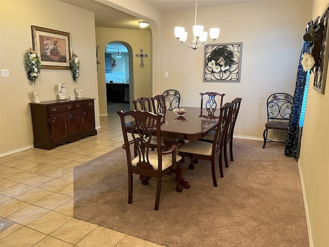 dining area featuring light tile patterned floors and a notable chandelier