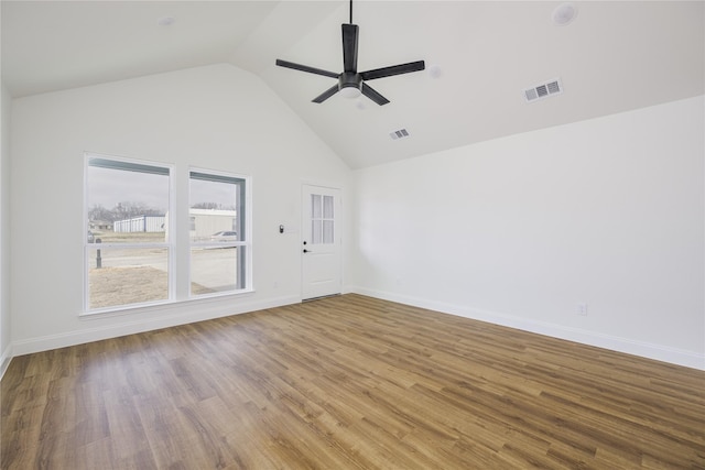 spare room featuring hardwood / wood-style flooring, high vaulted ceiling, and ceiling fan