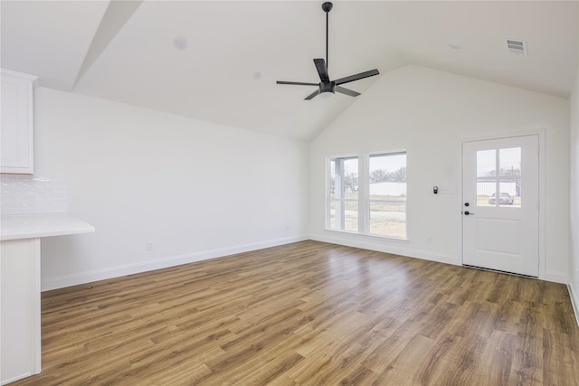 unfurnished living room featuring ceiling fan, high vaulted ceiling, and light hardwood / wood-style floors