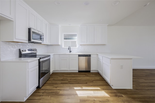 kitchen featuring sink, appliances with stainless steel finishes, dark hardwood / wood-style floors, kitchen peninsula, and white cabinets