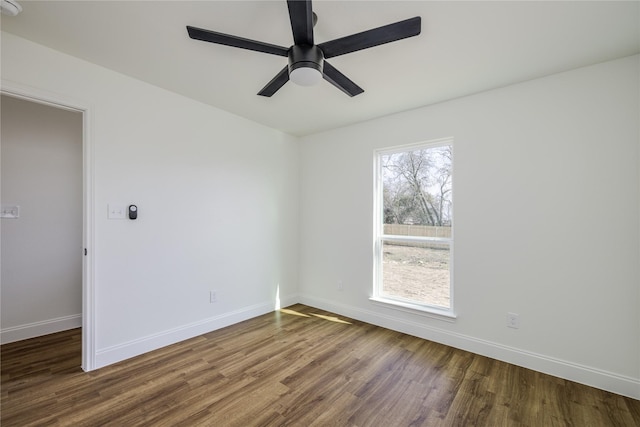 empty room featuring ceiling fan and dark hardwood / wood-style flooring