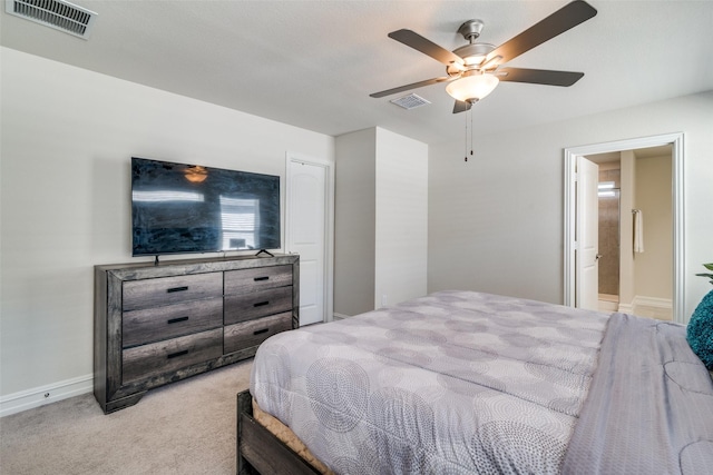 carpeted bedroom featuring ceiling fan and ensuite bathroom