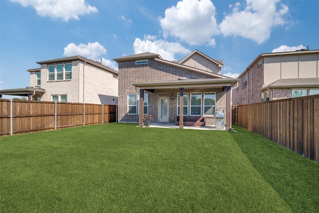 rear view of house with a lawn and a patio area