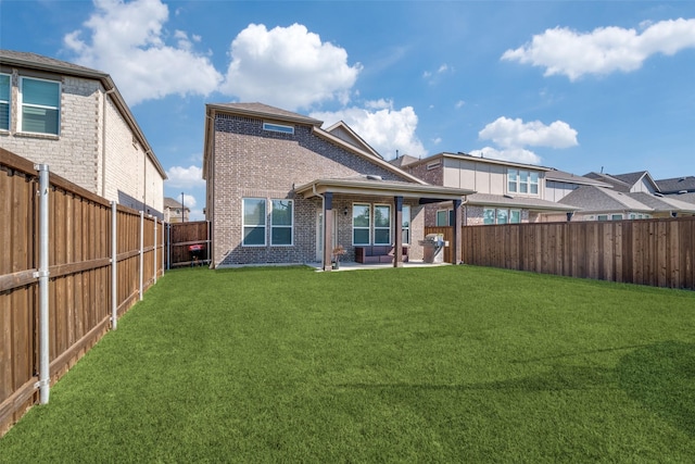 back of property featuring a yard and a patio