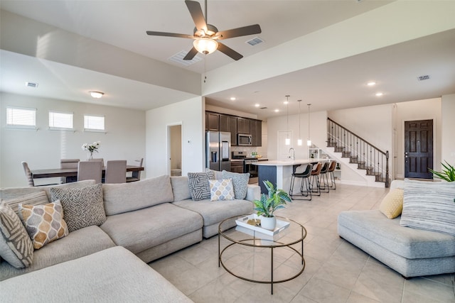 tiled living room with sink and ceiling fan