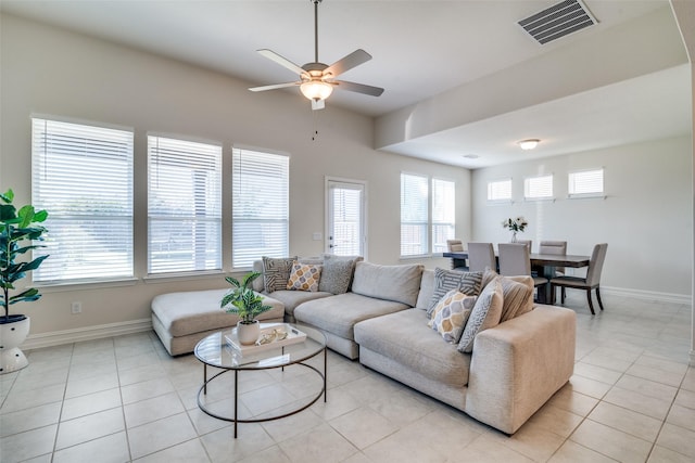 tiled living room with ceiling fan