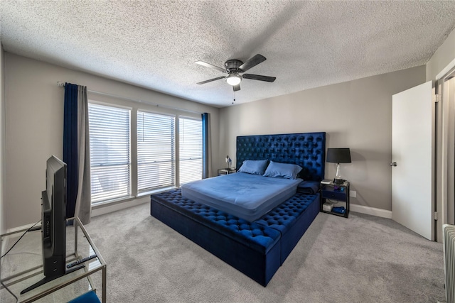 bedroom with light carpet, a textured ceiling, and ceiling fan