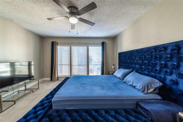 bedroom featuring ceiling fan, light colored carpet, and a textured ceiling