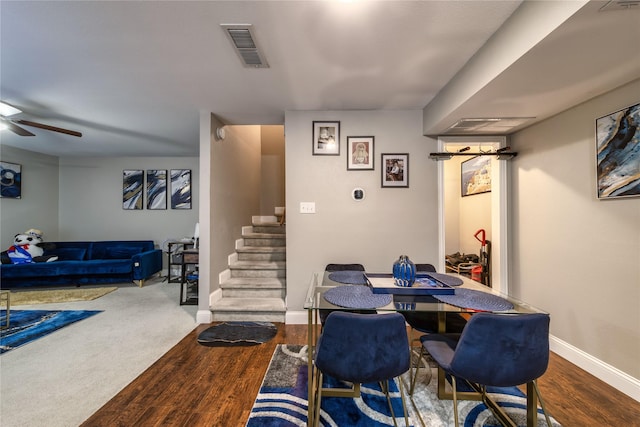 dining space with wood-type flooring and ceiling fan