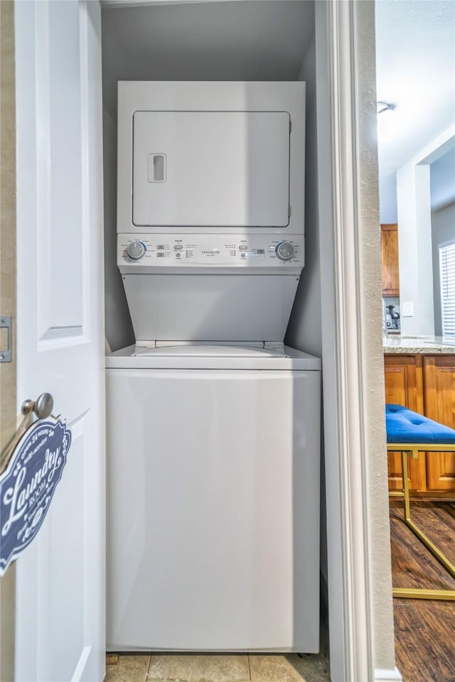 clothes washing area featuring stacked washer / drying machine