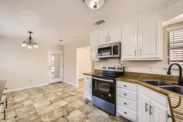 kitchen featuring stainless steel appliances, sink, pendant lighting, and white cabinets