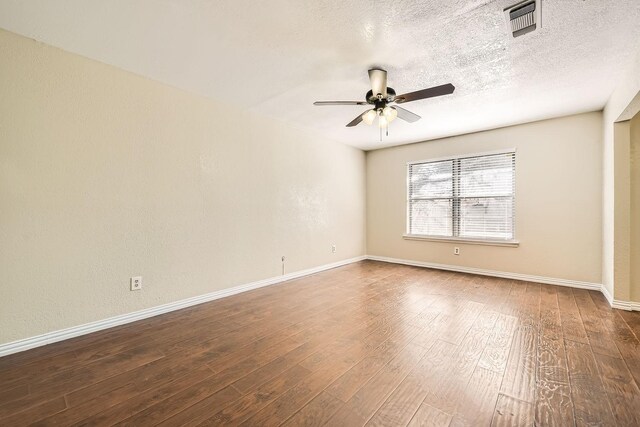 empty room featuring ceiling fan, wood-type flooring, and a textured ceiling