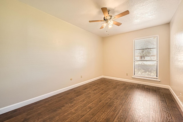 spare room with ceiling fan, dark wood-type flooring, and a textured ceiling