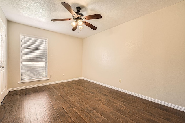 spare room featuring ceiling fan, dark wood-type flooring, and a textured ceiling