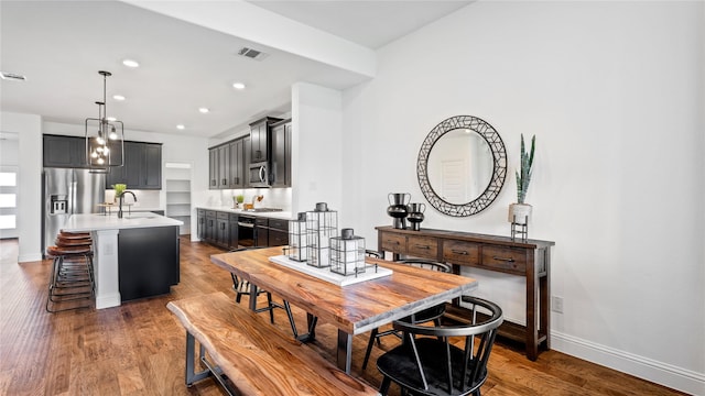 dining room with dark hardwood / wood-style floors and sink