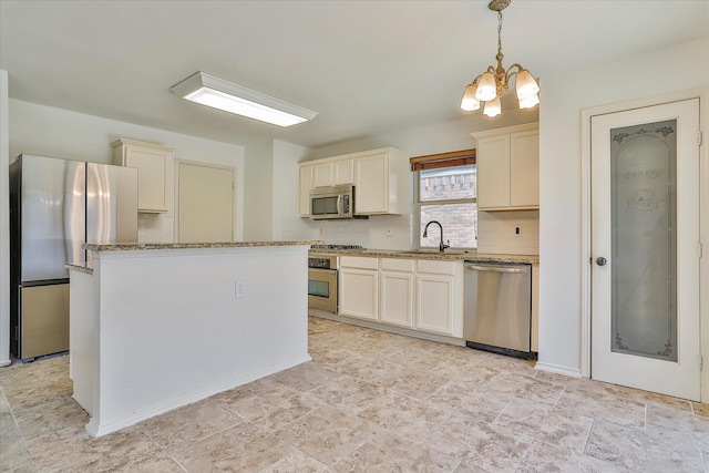 kitchen with a kitchen island, decorative light fixtures, decorative backsplash, stainless steel appliances, and an inviting chandelier