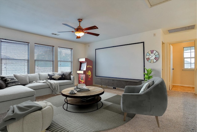 carpeted cinema room featuring ceiling fan