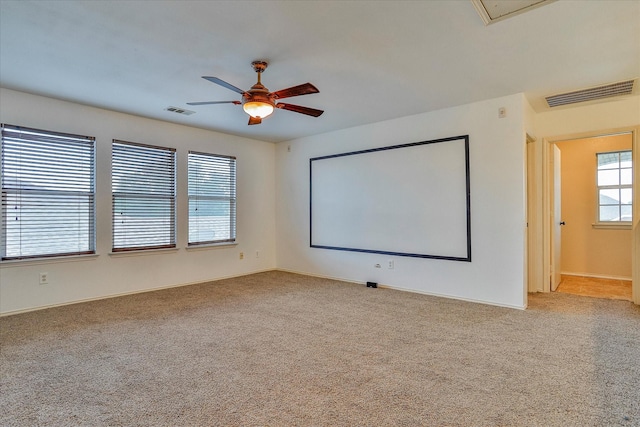 home theater featuring light carpet and ceiling fan