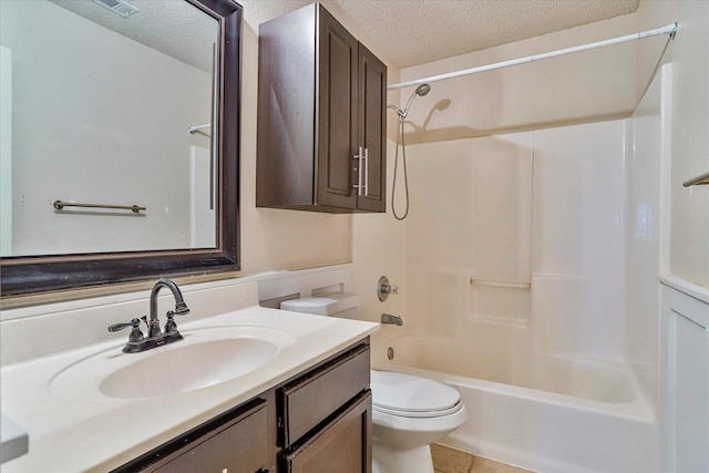 full bathroom featuring tile patterned flooring, vanity, toilet, bathing tub / shower combination, and a textured ceiling