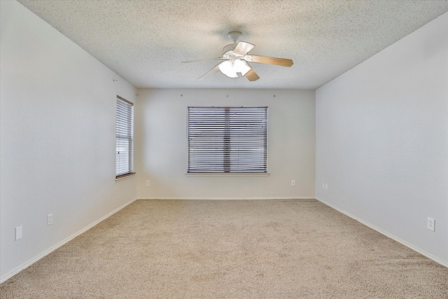 empty room featuring ceiling fan, carpet floors, and a textured ceiling