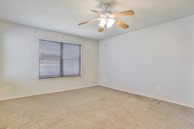 carpeted empty room featuring ceiling fan and a textured ceiling