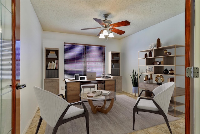 office featuring french doors, ceiling fan, and a textured ceiling